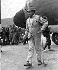 Bob Hope arriving in Vietnam with his signature golf club.